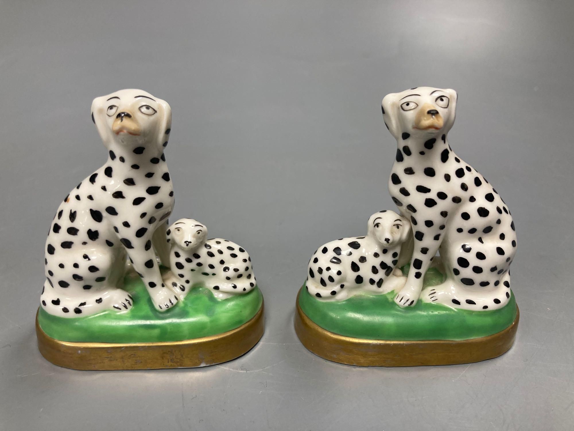 A pair of English porcelain King Charles Spaniels, 6.5cm high and a pair of Continental Dalmatians, 7.5cm high